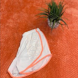 White and Neon pink Nike shorts